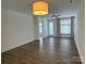 Bright living room with wood floors, fan and natural light from the windows and balcony at 1101 W 1St St # 408, Charlotte, NC 28202