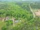 Aerial view of a wooded property featuring a home and surrounding greenery at 115 Patterson Rd, Kings Mountain, NC 28086