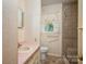 Full bathroom with tiled shower, window, sink, and toilet at 115 Patterson Rd, Kings Mountain, NC 28086