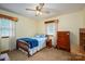 Cozy bedroom featuring a comfortable bed, wooden dresser, and bright natural light at 115 Patterson Rd, Kings Mountain, NC 28086