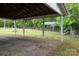 Shot from inside the white carport looking out at the green carport and green lawn at 115 Patterson Rd, Kings Mountain, NC 28086