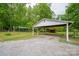 Exterior view of a carport with gravel parking and wooded scenery surrounding at 115 Patterson Rd, Kings Mountain, NC 28086