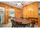 Inviting dining room with a large wooden table, wood paneled walls, and ceiling fan at 115 Patterson Rd, Kings Mountain, NC 28086