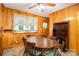 Charming dining room with wood paneling, wooden table, chairs and decorative ceiling fan at 115 Patterson Rd, Kings Mountain, NC 28086