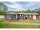 Exterior view of brick house with white trim, screened porch, tidy yard and back patio space at 115 Patterson Rd, Kings Mountain, NC 28086