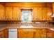 Close up of a practical kitchen sink space with a window view and wooden cabinetry at 115 Patterson Rd, Kings Mountain, NC 28086