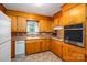 This kitchen features wood cabinets, modern appliances, a built-in oven, and tile floors at 115 Patterson Rd, Kings Mountain, NC 28086