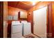 Laundry room with wood-paneled walls featuring a washer and dryer at 115 Patterson Rd, Kings Mountain, NC 28086