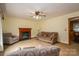 Cozy living room with a fireplace, comfortable seating, and a ceiling fan for added comfort at 115 Patterson Rd, Kings Mountain, NC 28086