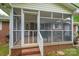 Exterior view of screened porch featuring brick construction and screen door at 115 Patterson Rd, Kings Mountain, NC 28086