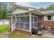Exterior of screened-in porch featuring brick foundation, siding, and outdoor furniture at 115 Patterson Rd, Kings Mountain, NC 28086