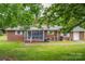 Charming brick home with a screened-in porch and a well-maintained lawn at 115 Patterson Rd, Kings Mountain, NC 28086