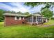 Quaint brick house with a screened-in porch and a spacious backyard at 115 Patterson Rd, Kings Mountain, NC 28086