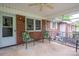 This screened porch features an outdoor sitting area with a fan overhead at 115 Patterson Rd, Kings Mountain, NC 28086