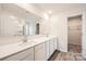 Elegant bathroom with double sinks, white cabinets, quartz countertop, and glass-enclosed shower at 118 Dorian Pl, Troutman, NC 28166