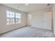 Bright bedroom with soft carpet, a large window overlooking the neighborhood and ample natural light at 118 Dorian Pl, Troutman, NC 28166