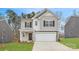 Charming two-story home featuring a two-car garage and inviting front porch, set in a landscaped yard at 118 Dorian Pl, Troutman, NC 28166