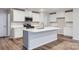 Modern kitchen with white cabinetry, stainless steel appliances, and a large center island at 118 Dorian Pl, Troutman, NC 28166