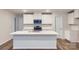 Beautiful kitchen showcasing stainless steel appliances, white cabinets, and a spacious center island at 118 Dorian Pl, Troutman, NC 28166