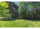 This large grassy backyard features established trees, creating a lush and serene environment at 12624 Cedar Crossings Dr, Charlotte, NC 28273