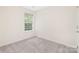 Bright bedroom features a large window, carpeted floors and neutral paint at 12624 Cedar Crossings Dr, Charlotte, NC 28273