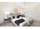 Well-lit bedroom with a plush bed, stylish side tables and a vaulted ceiling at 12624 Cedar Crossings Dr, Charlotte, NC 28273