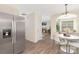 Inviting dining area with modern lighting and open layout to a living room with fireplace at 12624 Cedar Crossings Dr, Charlotte, NC 28273