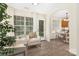 Inviting sunroom with neutral decor, large windows, and seamless flow to kitchen at 12624 Cedar Crossings Dr, Charlotte, NC 28273