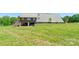 Spacious backyard with metal-roof home and covered area below, perfect for storing lawn and garden equipment at 1307 Tiffany Ln, Shelby, NC 28152