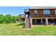 Backyard view of a rustic cabin with multi-level deck and covered area at 1307 Tiffany Ln, Shelby, NC 28152