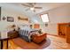 Cozy bedroom boasts a skylight, hardwood floors, decorative lamps and trunk, and comfortable bedding at 1307 Tiffany Ln, Shelby, NC 28152