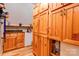Hallway features wood cabinets, storage, hardwood floors, and utility sink with mini refrigerator at 1307 Tiffany Ln, Shelby, NC 28152