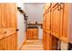 Hallway features wood cabinets, storage, hardwood floors, and utility sink with mini refrigerator at 1307 Tiffany Ln, Shelby, NC 28152