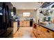 Bright kitchen with a center island, natural cabinets, and black appliances at 1307 Tiffany Ln, Shelby, NC 28152