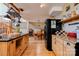 Kitchen shows wood cabinets, hardwood floors, granite countertops, island and dining area beyond at 1307 Tiffany Ln, Shelby, NC 28152