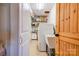 Functional laundry room space equipped with a utility sink, storage shelves, and a washing machine at 1307 Tiffany Ln, Shelby, NC 28152