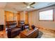 Relaxing living room area with wood trim, leather seating, a ceiling fan, and natural light at 1307 Tiffany Ln, Shelby, NC 28152