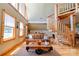 Cozy living room with hardwood floors, spiral staircase, and windows providing lots of natural light at 1307 Tiffany Ln, Shelby, NC 28152