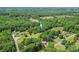 An aerial view shows the home in a neighborhood surrounded by trees at 1338 Pell Dr, Lincolnton, NC 28092