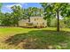 The backyard features a large lawn, fenced area, and a covered wooden deck at 1338 Pell Dr, Lincolnton, NC 28092