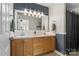 Bathroom features a double sink vanity, ample lighting, and contemporary finishes at 1338 Pell Dr, Lincolnton, NC 28092