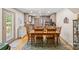 Warm dining area with a rustic wooden table, chairs for six, and a view into the adjoining kitchen at 1338 Pell Dr, Lincolnton, NC 28092