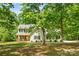 Charming two-story home featuring a welcoming porch, bright yellow front door, and beautifully landscaped front yard at 1338 Pell Dr, Lincolnton, NC 28092