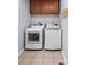 Convenient laundry room with modern washer and dryer units, overhead cabinets, and neutral tile flooring at 1338 Pell Dr, Lincolnton, NC 28092