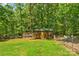 The wooden shed in the backyard has a chicken coop attached to it at 1338 Pell Dr, Lincolnton, NC 28092