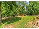 The wooden shed is in the backyard and surrounded by trees at 1338 Pell Dr, Lincolnton, NC 28092