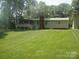 Large, well-maintained backyard with lush green grass and mature trees provides privacy at 146 Barclay Ln, Mooresville, NC 28115