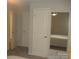 Bright bedroom showing doorways and a mirror reflecting the bed, offering spaciousness and functionality at 146 Barclay Ln, Mooresville, NC 28115