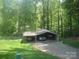 A shady carport features space for cars, boat and trailer at 146 Barclay Ln, Mooresville, NC 28115