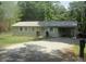 Charming ranch home featuring gravel driveway, metal roof, and mature landscaping at 146 Barclay Ln, Mooresville, NC 28115